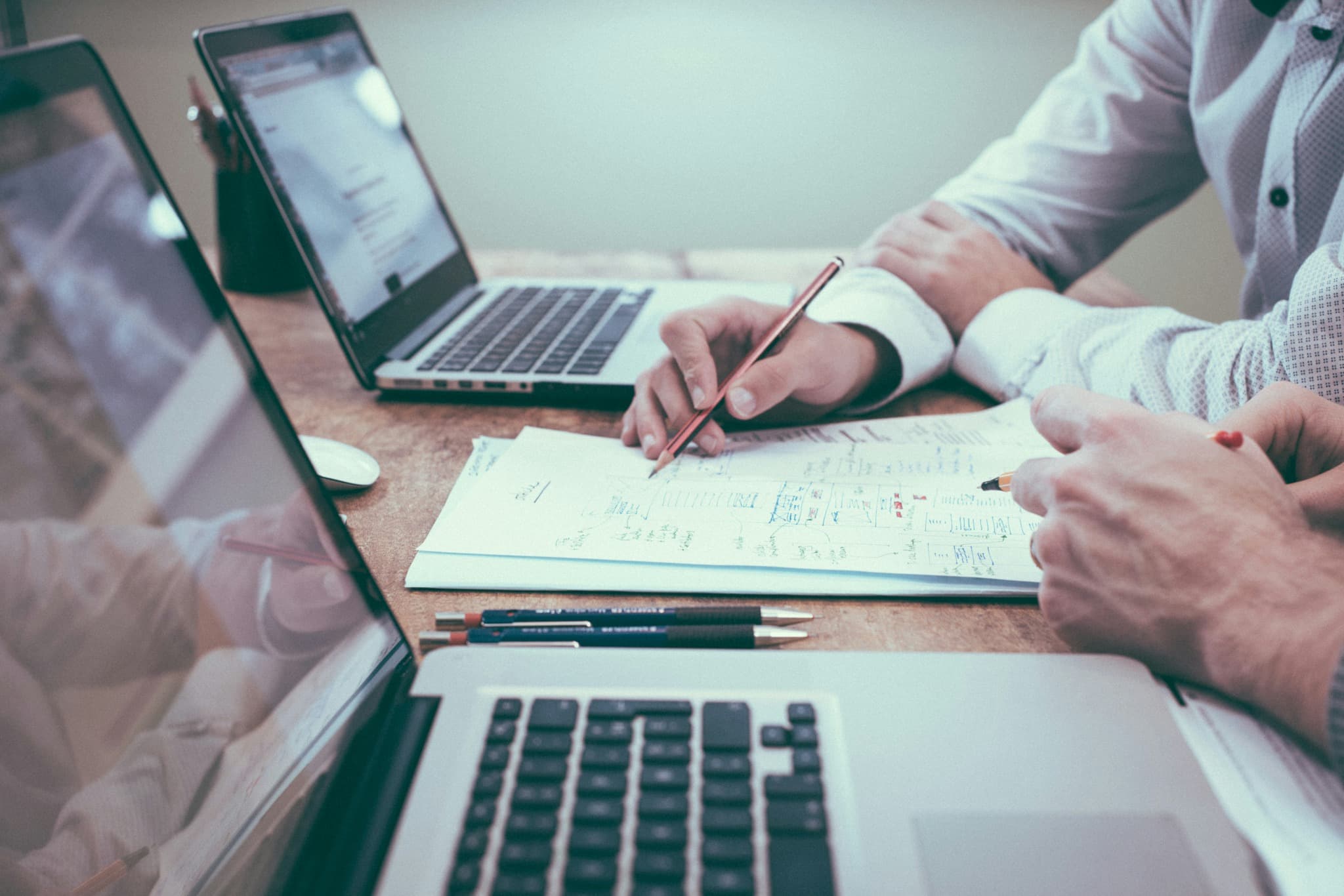 Professionals reviewing business plans and records