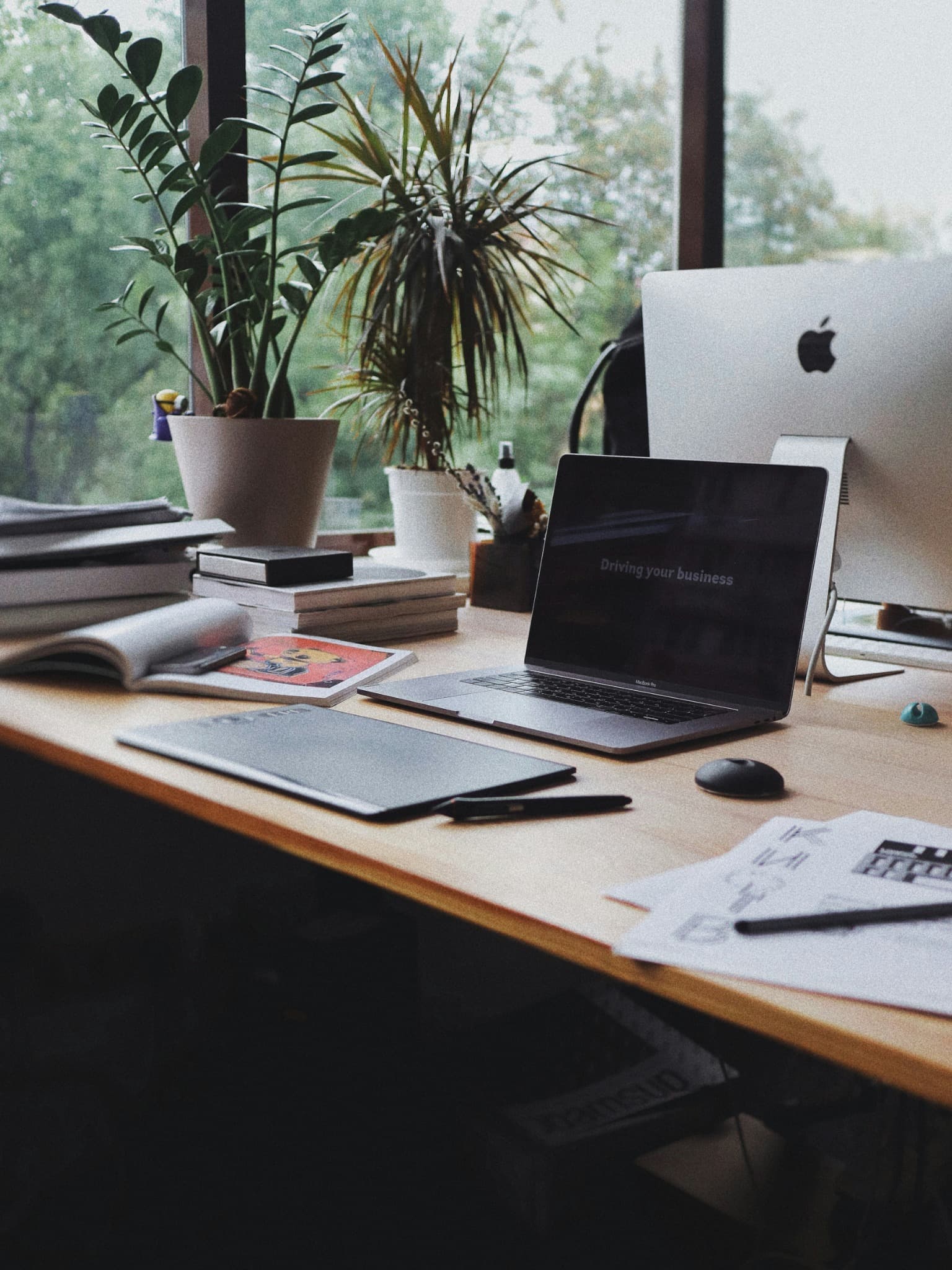 A professional workspace with notebooks and computers